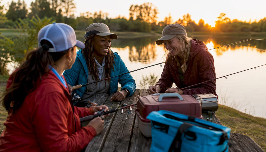 Group of women fishing on lake pier at dawn