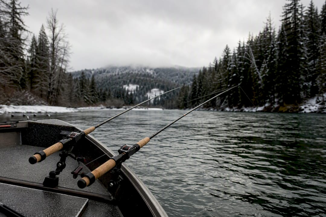 Fishing rods rigged for side drifting on winter river boat
