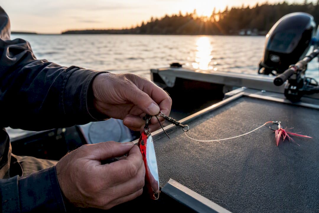 Hands assembling kokanee rig on boat deck
