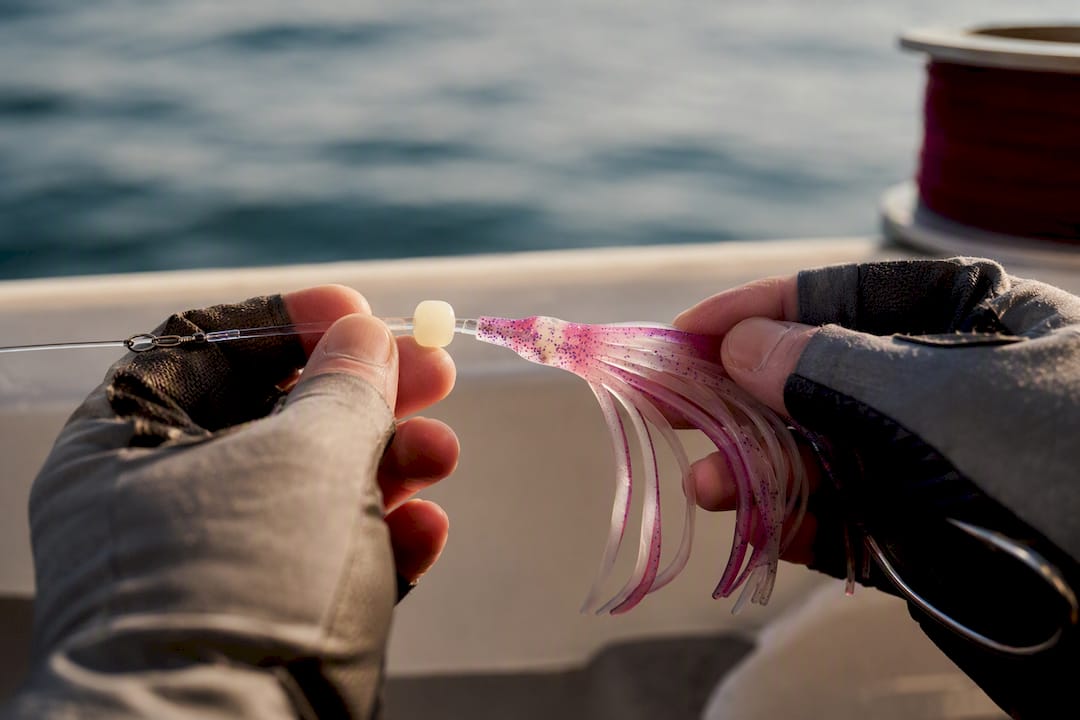 Angler assembling salmon hoochie rig