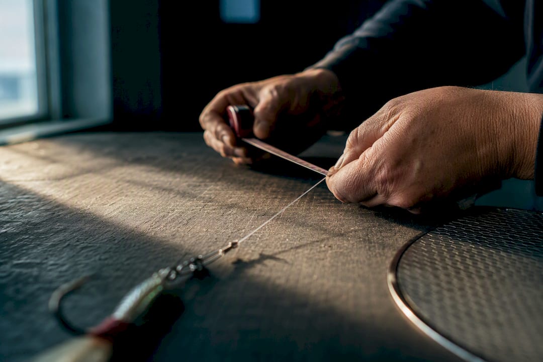 Angler measuring salmon flasher leader